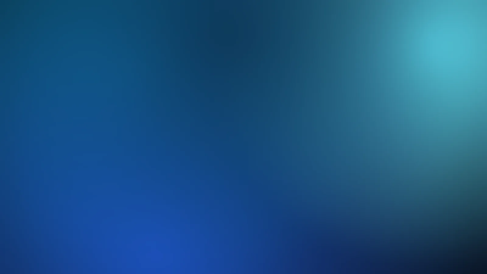 Teal and blue light over a dark ground